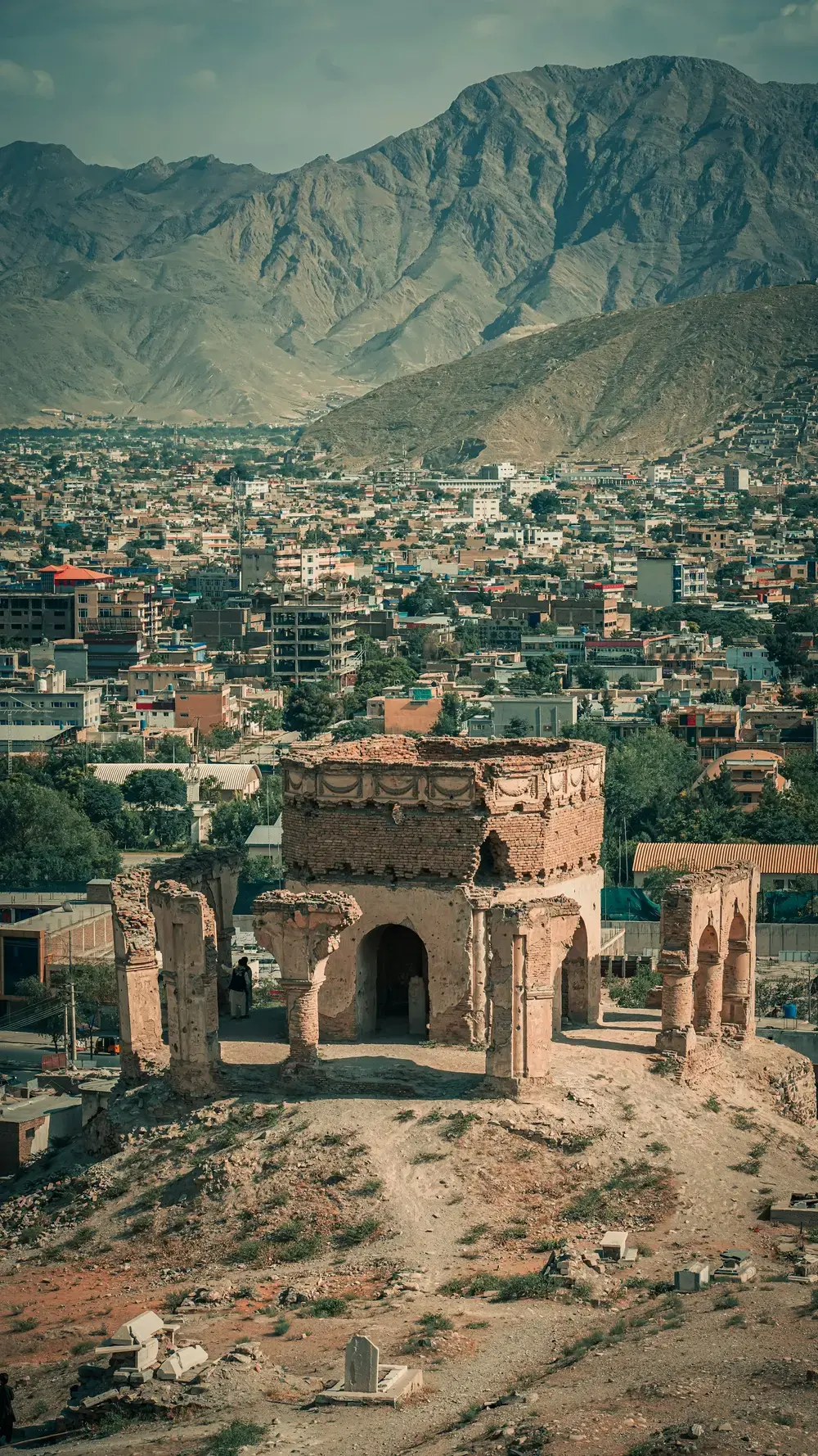 Historic hilltop structures overlooking a mountain city in Afghanistan