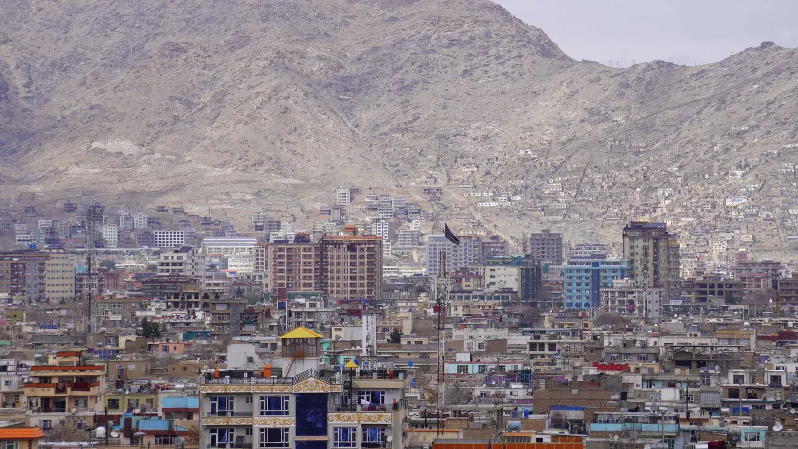 Kabul cityscape with residential hillsides and mountains, illustrating internal relocation in Afghanistan